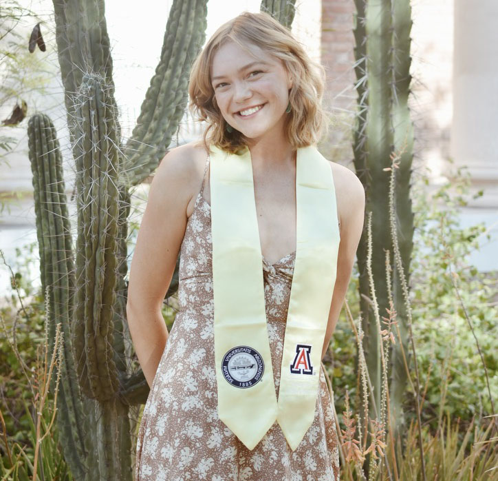 Professional headshot of Elsa Jacobson standing in front of pillar cactus