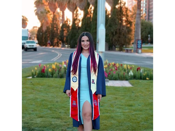 Professional photo of Jisselle Romero standing in front of the Old Main fountain on the UArizona campus